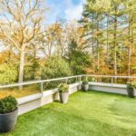 Comfortable balcony with artificial grass